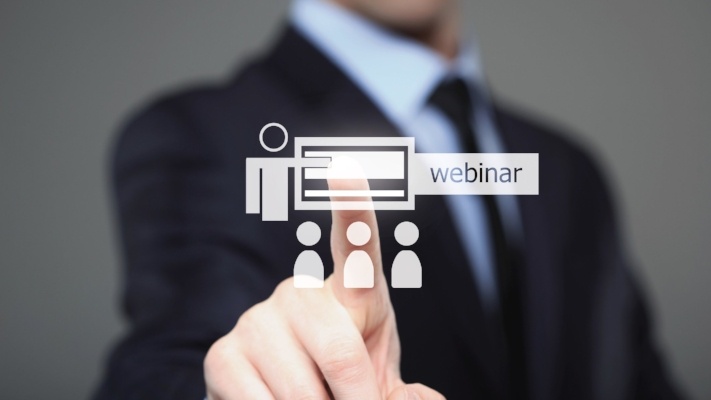 businessman pressing free webinar button on virtual screen