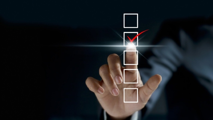 business person checking mark on checklist